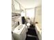 Bathroom with a tub, toilet, and a sink with mirror, and natural light at 306 Murray St, New Smyrna Beach, FL 32168