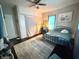 Bedroom has an oversized window, closet and a ceiling fan at 306 Murray St, New Smyrna Beach, FL 32168