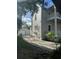 Side view of home and detached garage, showcasing the property's layout at 306 Murray St, New Smyrna Beach, FL 32168