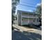 Two-story home featuring double porches, neutral siding, and a metal roof at 306 Murray St, New Smyrna Beach, FL 32168