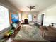 Relaxing living room featuring a ceiling fan, hardwood floors and abundant sunlight at 306 Murray St, New Smyrna Beach, FL 32168