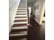 Stairway has wood banisters and white risers at 306 Murray St, New Smyrna Beach, FL 32168