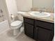 Bathroom featuring a sleek vanity with a modern sink, toilet, tub, and stylish fixtures at 3103 Nova Scotia Way, New Smyrna Beach, FL 32168