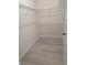 Walk-in closet featuring wire shelving and light wood flooring for organized storage at 3103 Nova Scotia Way, New Smyrna Beach, FL 32168