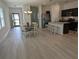 Bright dining area featuring light wood floors, a stylish chandelier, and views into the kitchen at 3103 Nova Scotia Way, New Smyrna Beach, FL 32168