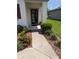 Inviting front door with colorful landscaping, leading to a welcoming home entrance at 3103 Nova Scotia Way, New Smyrna Beach, FL 32168