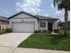 Charming single-story home featuring a well-maintained lawn, attached garage, and beautiful landscaping at 3103 Nova Scotia Way, New Smyrna Beach, FL 32168