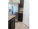 Modern kitchen featuring stainless steel refrigerator, dark cabinets, and neutral countertops at 3103 Nova Scotia Way, New Smyrna Beach, FL 32168