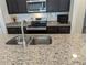Kitchen showcasing granite countertops, stainless steel appliances, and ample cabinet space at 3103 Nova Scotia Way, New Smyrna Beach, FL 32168