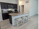 Open kitchen with granite countertops, a breakfast bar with stools, and modern appliances at 3103 Nova Scotia Way, New Smyrna Beach, FL 32168
