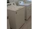 Convenient laundry room featuring a white washer and dryer set with light wood floors at 3103 Nova Scotia Way, New Smyrna Beach, FL 32168