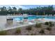 Relaxing poolside featuring lounge chairs and tables perfect for soaking up the sun and enjoying the outdoors at 3103 Nova Scotia Way, New Smyrna Beach, FL 32168