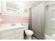 Clean bathroom with a shower-tub combination, pink wall tiles, and classic white vanity at 335 N Causeway # E3, New Smyrna Beach, FL 32169