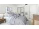 Serene bedroom with light grey and white décor, mirrored closet doors, and plenty of natural light at 335 N Causeway # E3, New Smyrna Beach, FL 32169