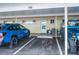 Covered parking spot with clearly marked space number and two parked vehicles at 335 N Causeway # E3, New Smyrna Beach, FL 32169