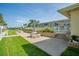 Inviting community pool area with patio seating and lush landscaping, perfect for relaxation and social gatherings at 335 N Causeway # E3, New Smyrna Beach, FL 32169