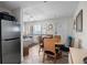 Bright dining area featuring a table with seating for four, adjacent to kitchen at 3509 S Atlantic Ave # 109, New Smyrna Beach, FL 32169