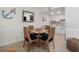 Dining area features table seating four, with nautical decor, and white cabinetry at 3509 S Atlantic Ave # 109, New Smyrna Beach, FL 32169
