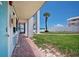 Exterior of a teal door condo with a palm tree and beach view at 3509 S Atlantic Ave # 109, New Smyrna Beach, FL 32169