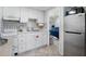 Efficient kitchen with white cabinetry and stainless steel appliances at 3509 S Atlantic Ave # 109, New Smyrna Beach, FL 32169