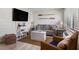Inviting living room with a cozy couch, woven furniture, oars, and a flat screen television at 3509 S Atlantic Ave # 109, New Smyrna Beach, FL 32169