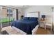 Comfortable bedroom with a queen bed, sliding glass door, and outdoor view at 3509 S Atlantic Ave # 109, New Smyrna Beach, FL 32169