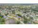 High-angle view of a residential neighborhood with tree-lined streets, attractive landscaping, and a tranquil pond feature at 357 Hearthstone Ter, Port Orange, FL 32127