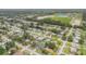 Scenic aerial view of a residential community featuring verdant lawns, mature trees, and a picturesque pond at 357 Hearthstone Ter, Port Orange, FL 32127