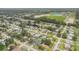Scenic aerial view of a residential community featuring verdant lawns, mature trees, and a picturesque pond at 357 Hearthstone Ter, Port Orange, FL 32127