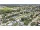 Expansive aerial view of a quiet neighborhood with mature trees and well-maintained homes near a green open space at 357 Hearthstone Ter, Port Orange, FL 32127
