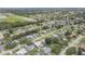 Expansive aerial view of a quiet neighborhood with mature trees and well-maintained homes near a green open space at 357 Hearthstone Ter, Port Orange, FL 32127