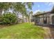 Lush backyard with a screened in lanai and tall privacy fence at 357 Hearthstone Ter, Port Orange, FL 32127