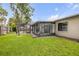 Spacious backyard with an enclosed lanai and lush green grass at 357 Hearthstone Ter, Port Orange, FL 32127