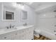 Bathroom features double sinks, white cabinetry, bathtub/shower combo and natural light at 357 Hearthstone Ter, Port Orange, FL 32127