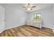 Bedroom with a decorative daybed, ceiling fan, wood-look flooring and natural light at 357 Hearthstone Ter, Port Orange, FL 32127