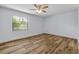 Bright bedroom with modern ceiling fan, neutral paint, and wood-look flooring at 357 Hearthstone Ter, Port Orange, FL 32127