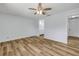 Fresh bedroom with neutral walls, wood-look flooring, and a ceiling fan at 357 Hearthstone Ter, Port Orange, FL 32127