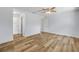Spacious bedroom featuring wood-look flooring, neutral paint, and multiple doorways at 357 Hearthstone Ter, Port Orange, FL 32127