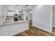 Open kitchen with stainless steel appliances, white cabinets, and decorative pendant lighting at 357 Hearthstone Ter, Port Orange, FL 32127