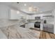 Modern kitchen boasts stainless steel appliances, stylish countertops, and white cabinets at 357 Hearthstone Ter, Port Orange, FL 32127