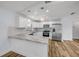 Modern kitchen boasts stainless steel appliances, stylish countertops, and white cabinets at 357 Hearthstone Ter, Port Orange, FL 32127