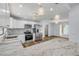 Open kitchen with stainless steel appliances, white cabinets, and decorative pendant lighting at 357 Hearthstone Ter, Port Orange, FL 32127