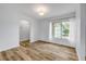 Bright room with wood-look floors, fresh paint, and a window with sheer curtains for natural light at 357 Hearthstone Ter, Port Orange, FL 32127