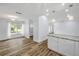 Bright living room featuring light-colored walls, wood-look floors, and natural light from a large window at 357 Hearthstone Ter, Port Orange, FL 32127