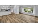 Inviting living space showcases durable floors, leading to an open kitchen with white cabinets and countertops at 357 Hearthstone Ter, Port Orange, FL 32127