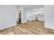 Open living area with wood-look floors, neutral walls, and view into the updated kitchen at 357 Hearthstone Ter, Port Orange, FL 32127