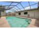 Inviting pool with screened enclosure surrounded by lush landscaping and a privacy fence at 357 Hearthstone Ter, Port Orange, FL 32127