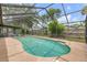 Inviting pool with screened enclosure surrounded by lush landscaping and a privacy fence at 357 Hearthstone Ter, Port Orange, FL 32127
