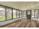 Sunroom features wood-look flooring, black framed windows and access to the backyard pool at 357 Hearthstone Ter, Port Orange, FL 32127