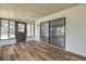 Sunroom featuring wood-look floors, sliding glass doors, and access to the backyard pool at 357 Hearthstone Ter, Port Orange, FL 32127